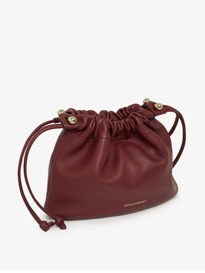 Strathberry Oxblood Charlotte drawstring bag at Collagerie