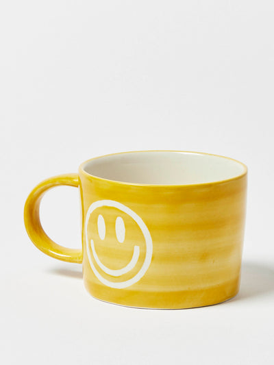 Oliver Bonas Smiley face yellow ceramic mug at Collagerie