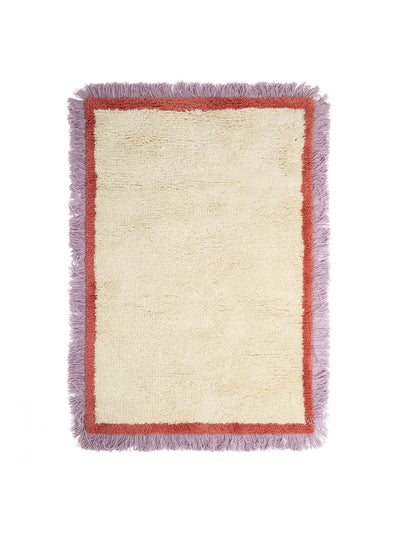 Oliver Bonas Danton purple fringed white fluffy rug at Collagerie