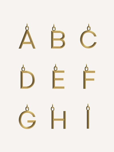 Dévé Large gold Alphabet charm at Collagerie