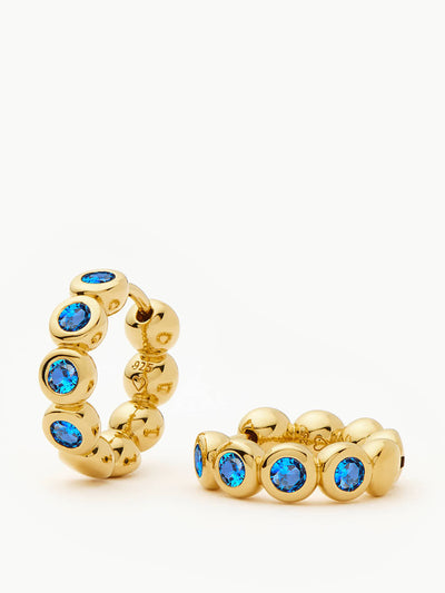 Missoma Tennis small hoop earrings in gold vermeil and sapphire blue nano crystal at Collagerie