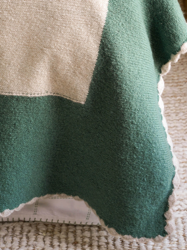 Green bordered knitted throw
