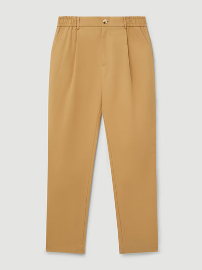 Ché Studios. Tan pleated chino trousers at Collagerie