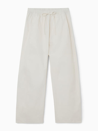 Cos Elasticated barrel-leg trousers at Collagerie