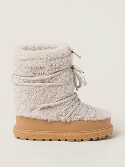 Miu Miu Shearling après-ski boots at Collagerie