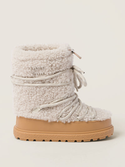 Miu Miu Shearling ski boots at Collagerie