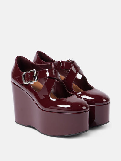 Alaïa Criss Cross patent leather wedges at Collagerie