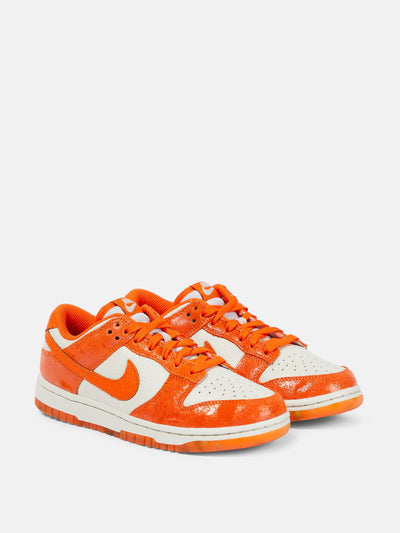 Nike Dunk Low suede-trimmed sneakers in orange and white at Collagerie