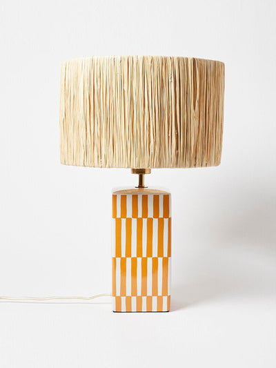 Oliver bonas Orange ceramic and raffia table lamp at Collagerie