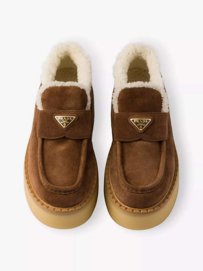 Prada Shearling-lined suede loafers at Collagerie