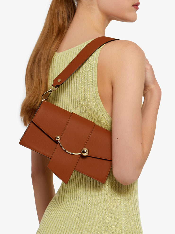 This versatile day-to-evening Strathberry bag can be worn as a clutch, over the shoulder, or as a crossbody using the chain strap. Collagerie.com