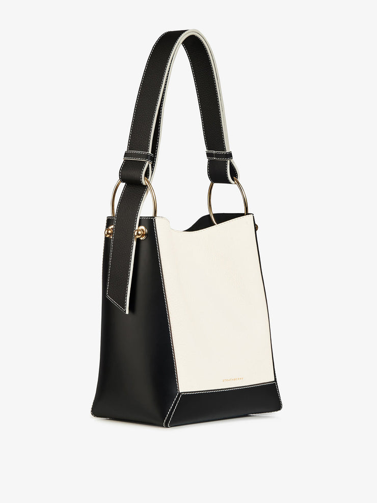 The perfect everyday Strathberry leather bucket bag, made large enough to carry necessities. Adjustable wide leather shoulder and crossbody strap. Collagerie.com