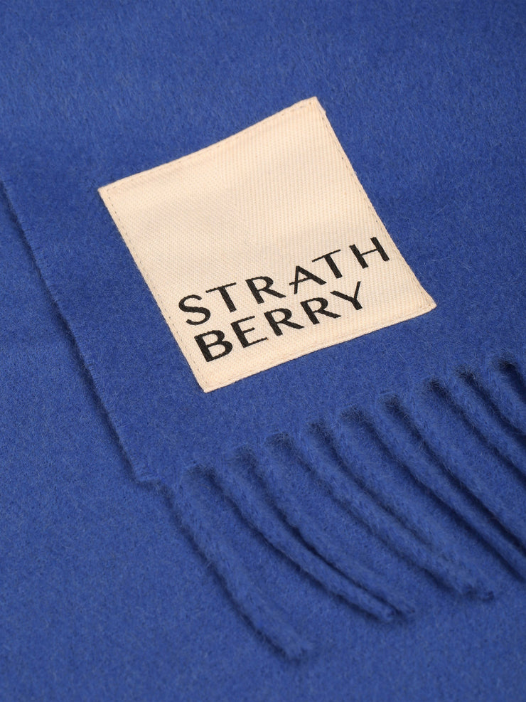 The classic, minimalist design transcends seasons and trends, ensuring this Strathberry scarf will remain a wardrobe staple for years to come. Collagerie.com
