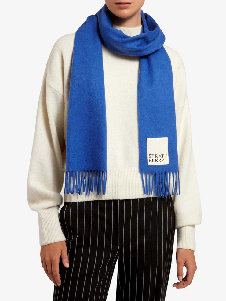 The classic, minimalist design transcends seasons and trends, ensuring this Strathberry scarf will remain a wardrobe staple for years to come. Collagerie.com