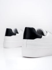 The Mrs A, a chic trainer made from white leather with contrasting black heel tab. Stylish and comfortable cushioned footbed. Recycled shoebag included. collagerie.com