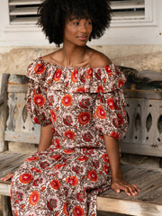Beautiful hand-blocked fabric off shoulder dress by Rae Feather. Brown, orange and red dress perfect for the Summer and holiday | Collagerie.com