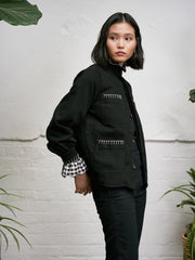 The perfect trans-seasonal shacket in black denim from Seventy + Mochi. Loose fitting body with balloon sleeve shaping and hand-done blanket stitching. Collagerie.com