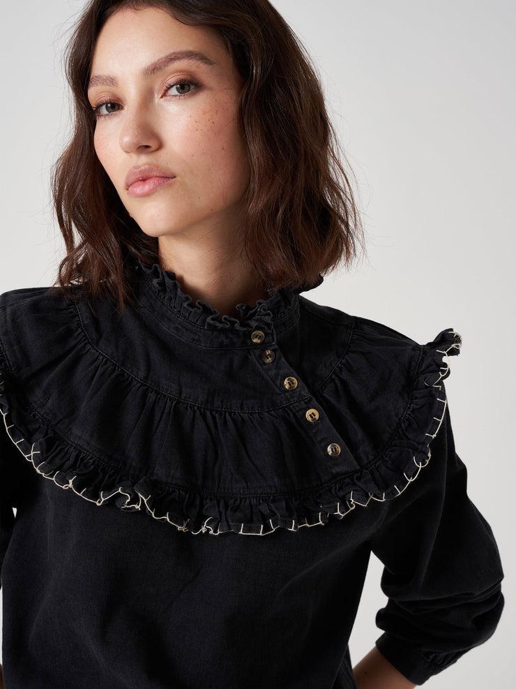 Perfect Seventy + Mochi fall blouse. Sustainable washed black denim with hand-stitched details. Featuring a high-neckline and statement shoulder shape. Collagerie.com
