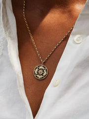 Diamond and black enamel flower coin necklace
