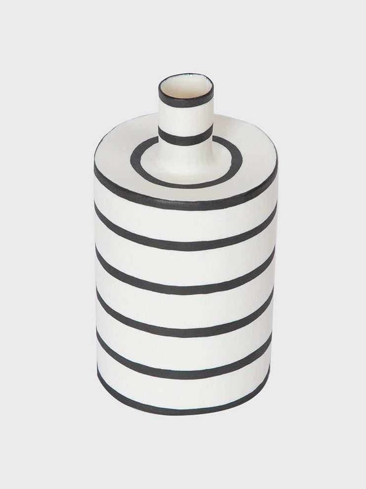 This cylindrical Hadeda bud vase, decorated with a monochrome line design, is perfect for brightening a windowsill, desk or breakfast tray. Collagerie.com