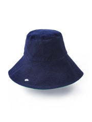 Reversible green and navy towelling bucket hat by Rae Feather. Great addition to your Summer wardrobe and made out of towelling cotton | Collagerie.com