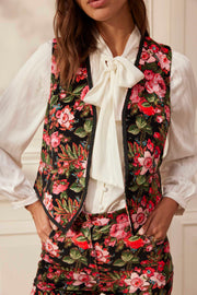 A wild bouquet of blush-hued winter roses scattered on a black background makes this romantic Yolke waistcoat a perfect Autumn accessory. Collagerie.com