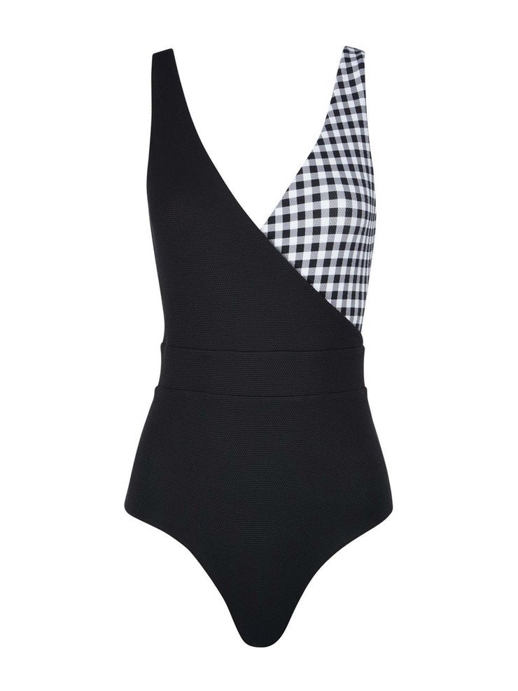 The Ashley black and white gingham swimsuit from Cossie + Co, with a modern v-neck, wrap over one-piece and flattering waist. The wrap over silhouette gives great support at the bust. Medium rise leg + medium coverage on the bottom. 