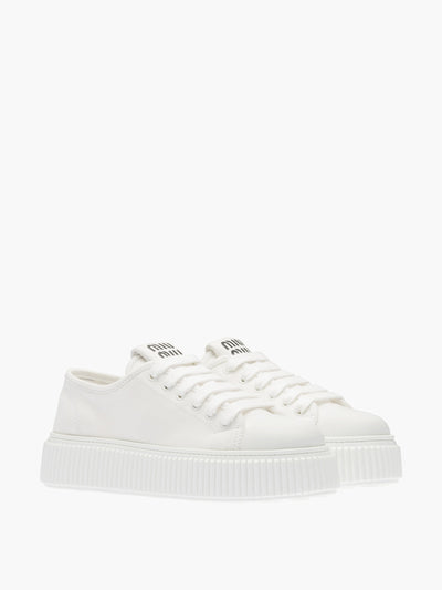 Miu Miu White denim sneakers at Collagerie