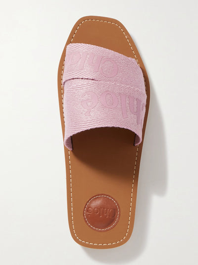 Chloé Woody logo-print canvas slides at Collagerie