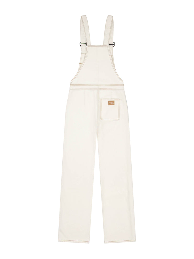 A must-have item for your forever wardrobe. This ecru white denim Seventy + Mochi dungaree features ankle-grazing hems and adjustable straps. Collagerie.com