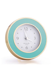 Turquoise blue enamel silent alarm clock finished in gold plate with a luxury dove grey velvet back by Addison Ross. Desk or bedside round clock | Collagerie.com