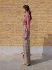 A classic trouser shape made from British check wool in cherry toffee with it’s wide-leg and high-waisted with patch pockets in the front by Anna Mason. Collagerie.com